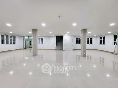 Spacious open-plan interior with tiled flooring and ample natural light, perfect for versatile use.