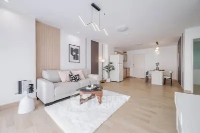 Spacious modern living room with elegant decor and open kitchen layout, perfect for stylish urban living.