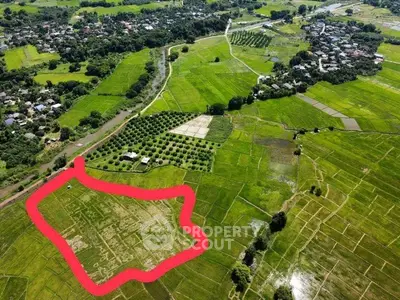 Aerial view of expansive green farmland with marked plot, ideal for development or agriculture.