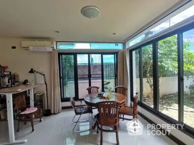 Bright dining area with large windows and garden view