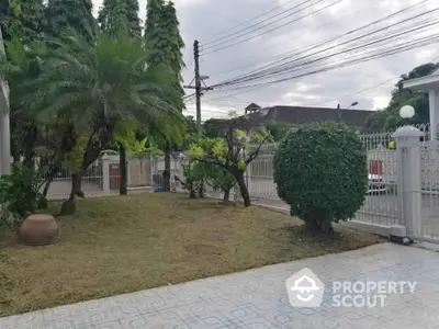 Charming garden view with lush greenery and spacious tiled patio