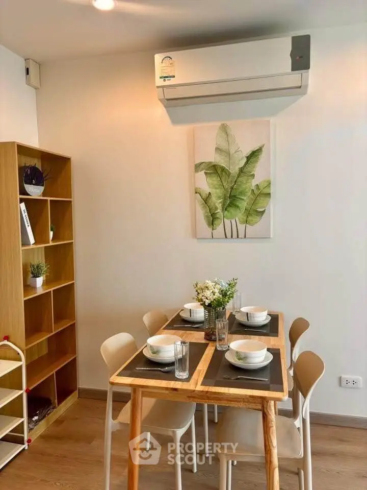 Charming dining area with modern decor and air conditioning, perfect for cozy meals.