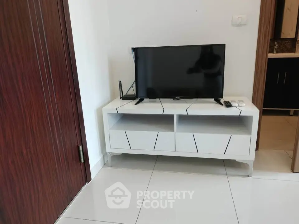 Modern living room with sleek TV stand and flat-screen TV