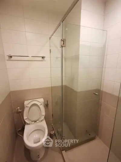 Modern bathroom with glass shower enclosure and tiled walls