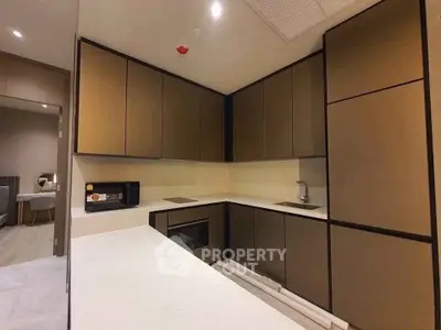 Modern kitchen with sleek cabinetry and built-in appliances in a contemporary apartment.