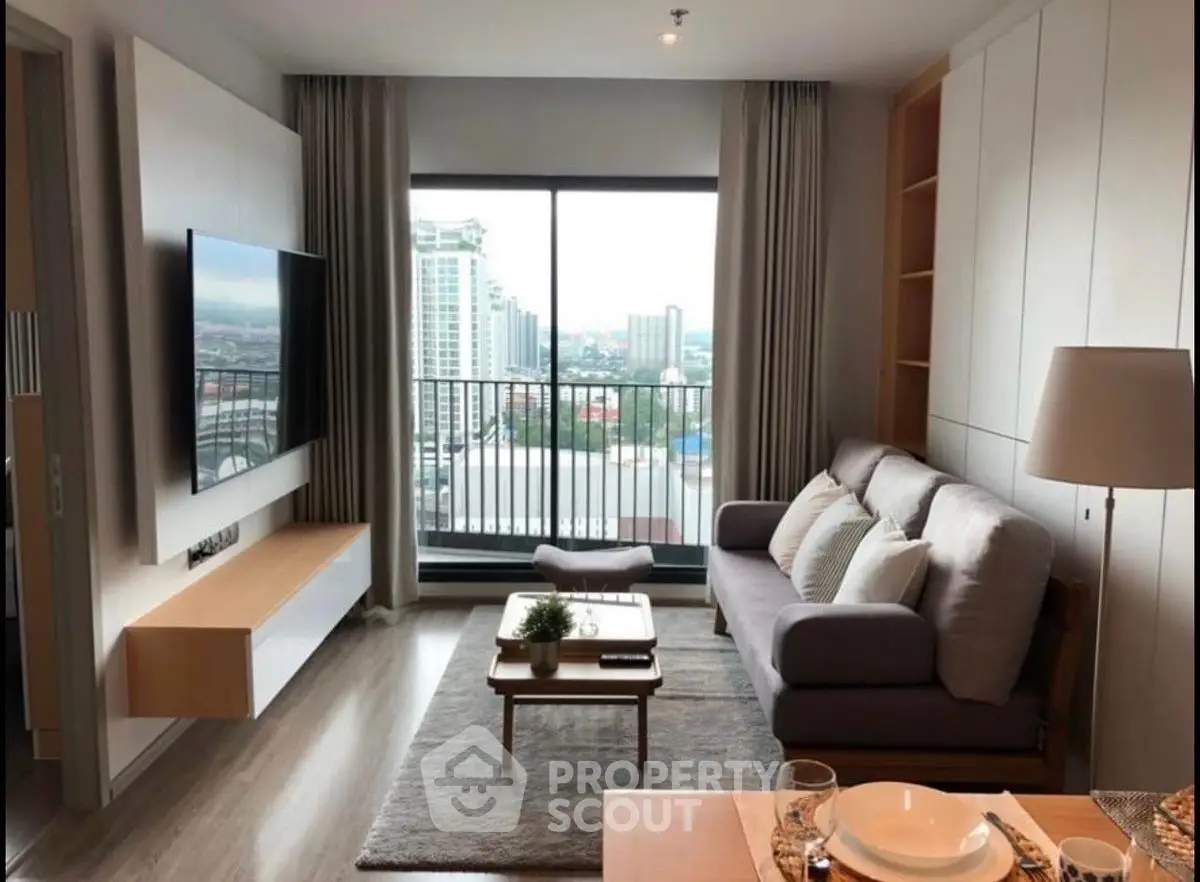 Modern living room with city view and stylish furniture in high-rise apartment.