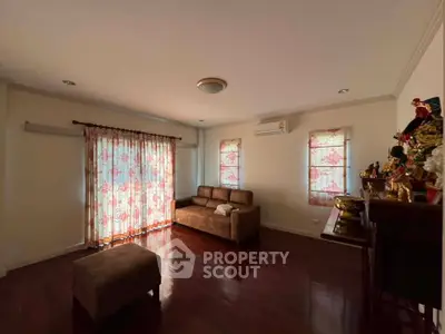 Spacious living room with elegant wooden flooring and stylish decor