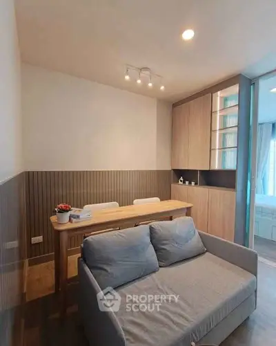 Modern living room with cozy sofa and dining area in stylish apartment