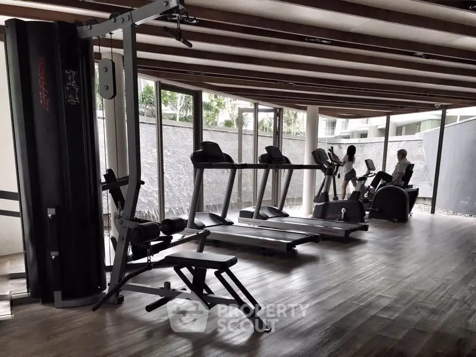 Modern gym with state-of-the-art equipment in a luxury residential building.