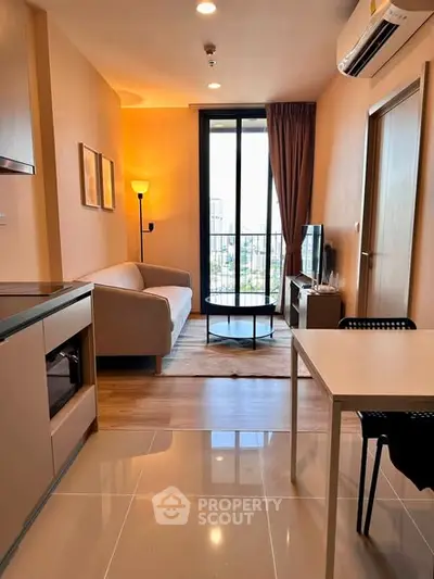 Modern living room with city view, featuring cozy sofa, sleek furniture, and large window for natural light.