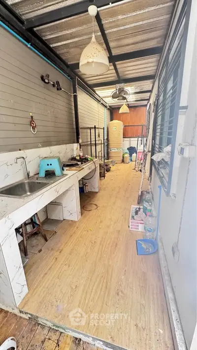 Spacious utility area with sink and storage in modern home