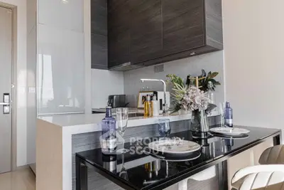 Modern kitchen with sleek cabinetry and elegant dining setup in a stylish apartment.