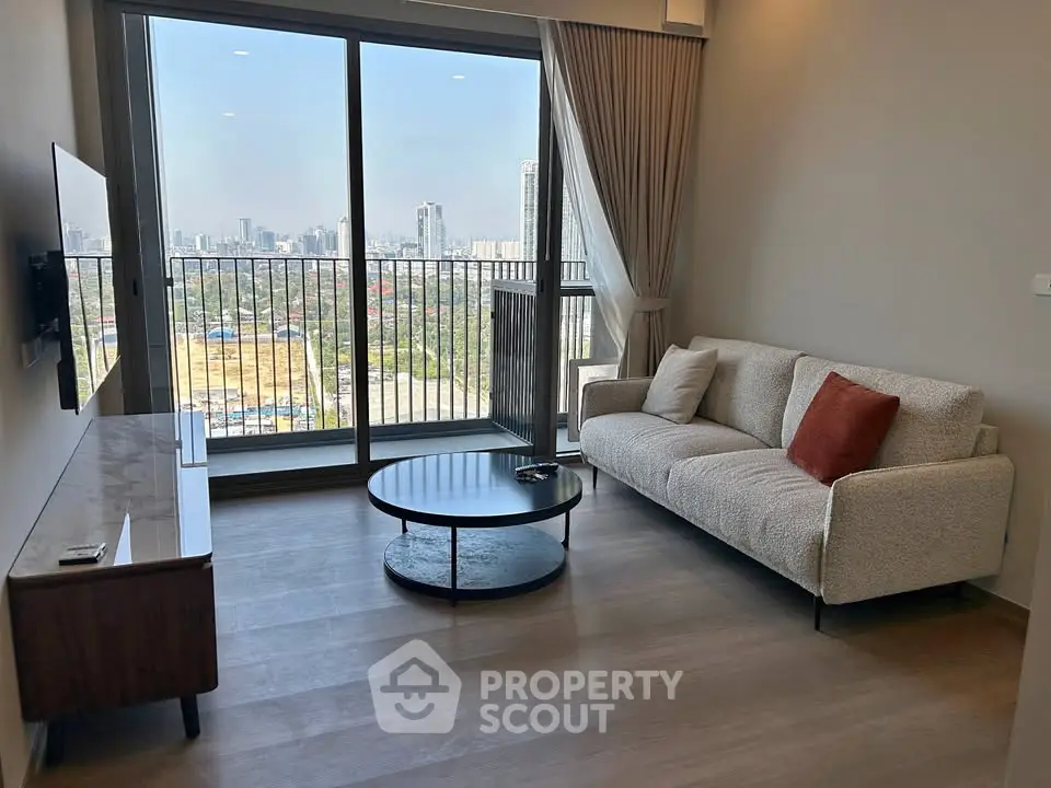 Modern living room with city view, featuring cozy sofa and sleek furniture, perfect for urban living.