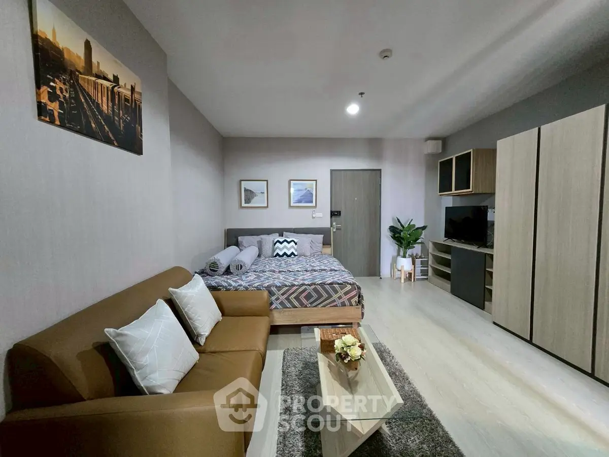 Modern studio apartment with cozy living area and stylish decor