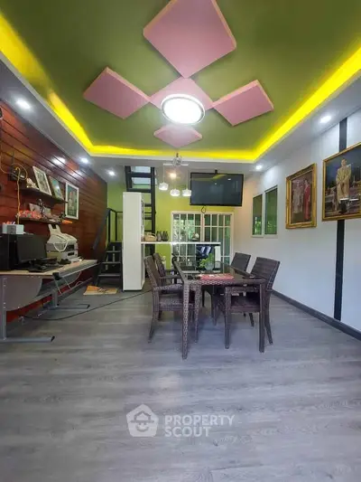 Stylish modern living room with unique ceiling design and elegant dining area.