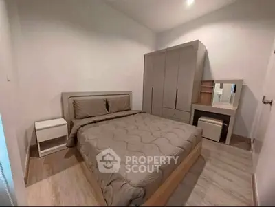 Cozy bedroom with modern furnishings and ample storage space