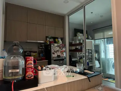 Modern kitchen with sleek cabinetry and integrated appliances, featuring a washing machine and ample storage space.
