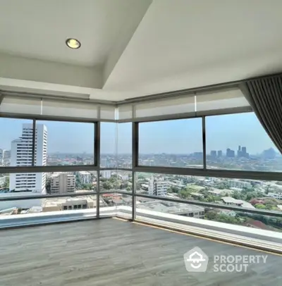 Spacious corner unit with panoramic city views and abundant natural light.