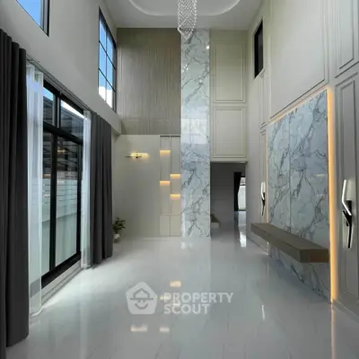 Luxurious modern living room with high ceilings and marble accents