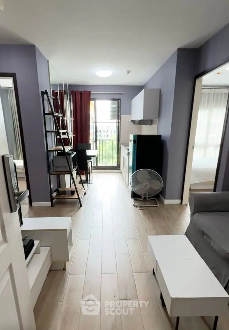 Modern apartment interior with stylish decor and open layout, featuring a cozy living area and balcony view.