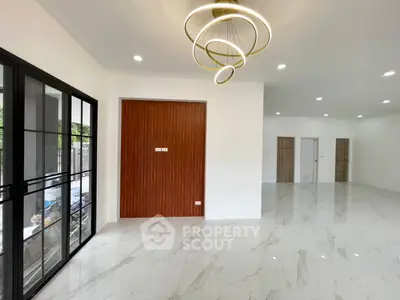 Spacious modern living room with elegant chandelier and marble flooring