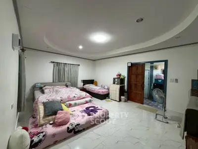 Spacious bedroom with double beds and modern ceiling lights