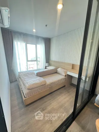 Modern bedroom with twin beds and large window in a stylish apartment