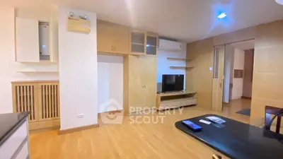 Spacious living room with modern wooden cabinetry and sleek flooring