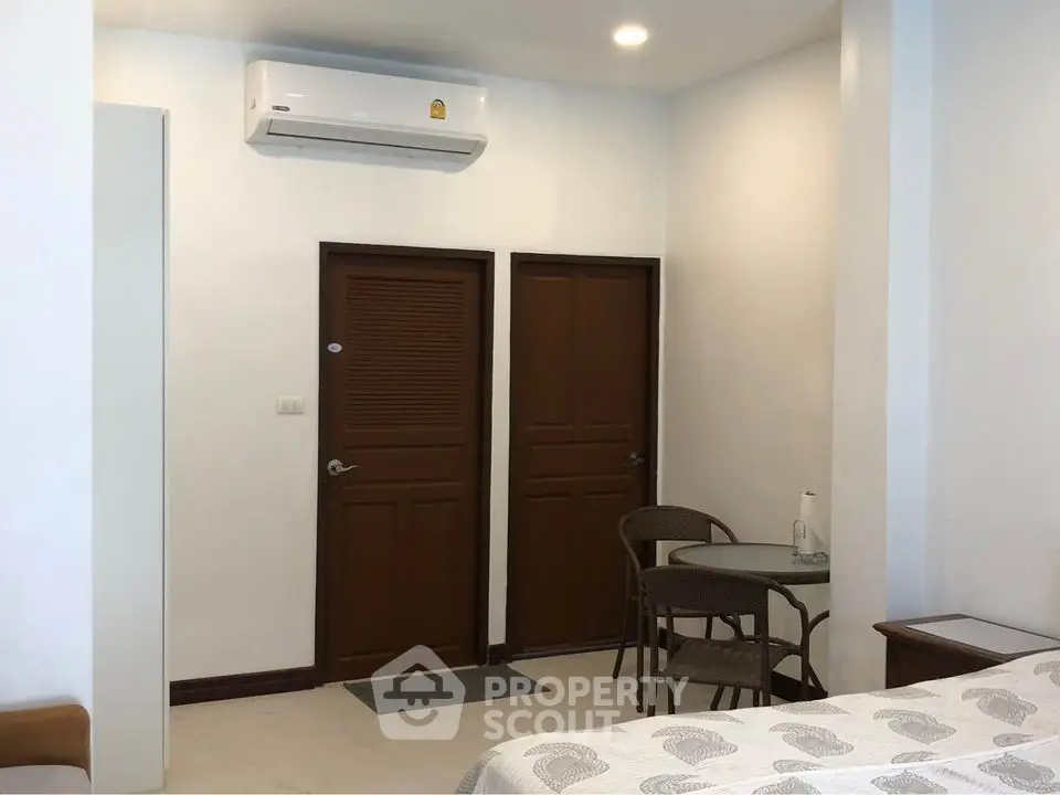 Cozy bedroom with air conditioning and small seating area