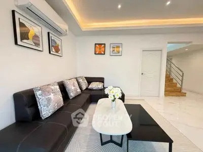Modern living room with stylish black sofa and elegant decor