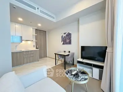 Modern living room with open kitchen, stylish decor, and cozy seating area in a contemporary apartment.