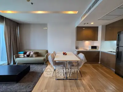 Modern open-plan living room and kitchen with sleek design and cozy ambiance.