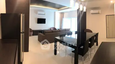 Spacious modern living room with sleek furniture and air conditioning, perfect for comfort and style.