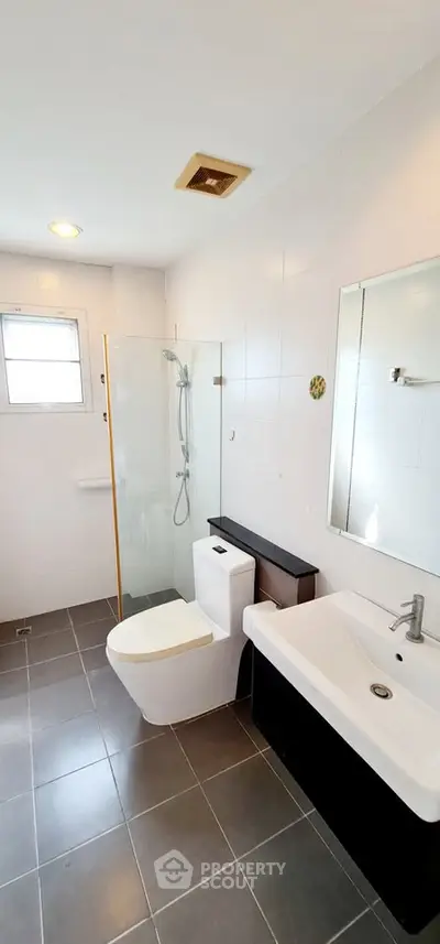 Modern bathroom with sleek fixtures and glass shower enclosure