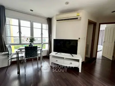 Modern living room with large windows and stylish furniture in a cozy apartment.