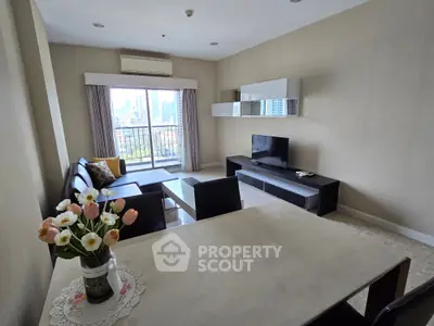 Spacious living room with modern furniture and city view balcony, perfect for urban living.