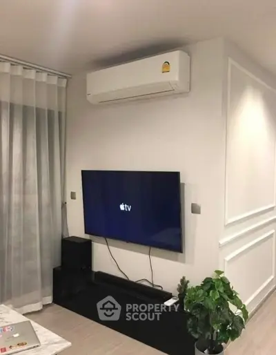 Modern living room with wall-mounted TV and air conditioning