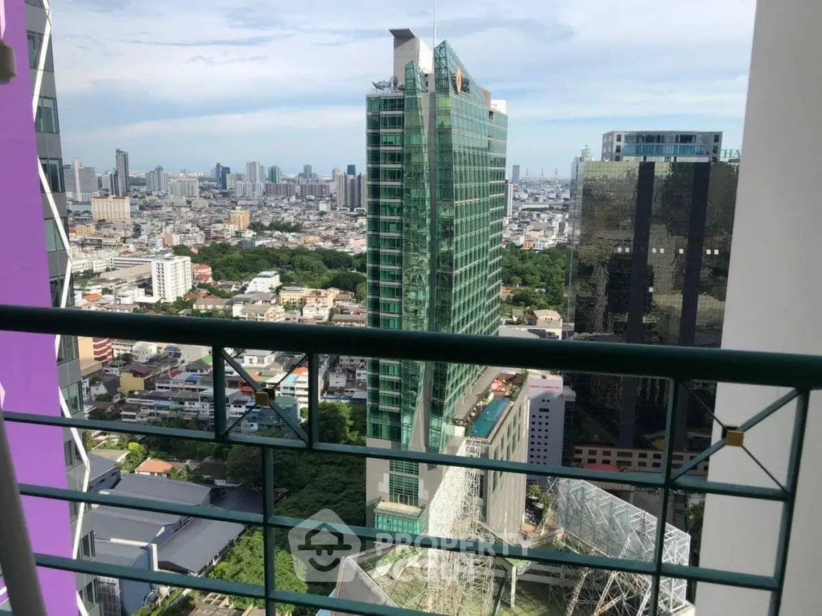 Stunning cityscape view from a high-rise balcony overlooking modern skyscrapers.
