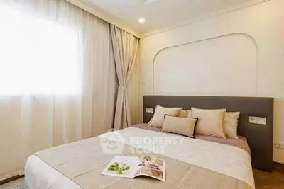 Cozy bedroom with elegant decor and natural light, perfect for relaxation.