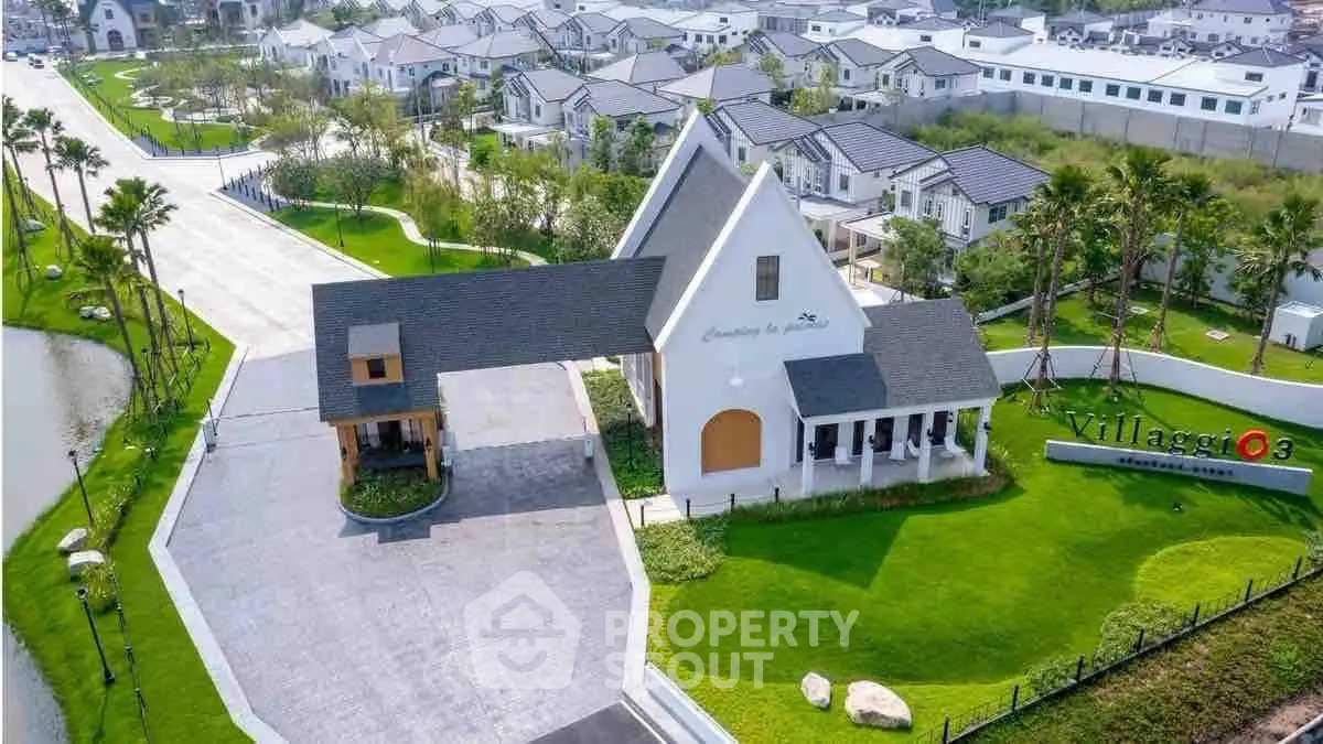 Aerial view of a modern residential community with landscaped gardens and stylish architecture.