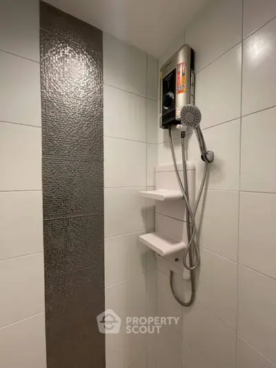 Modern bathroom with sleek shower design and tiled wall accent