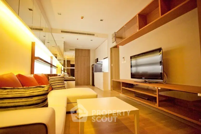 Modern living room with stylish furniture and ambient lighting in a cozy apartment.