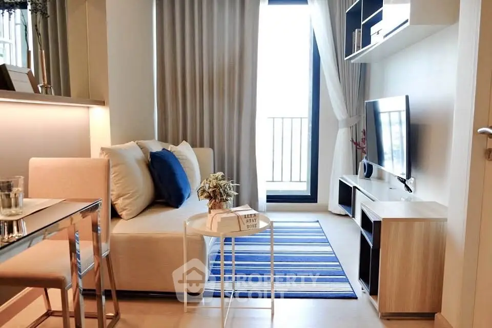 Modern living room with cozy sofa, stylish decor, and natural light from balcony window.