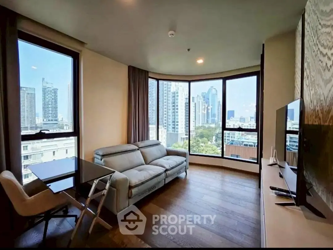 Luxurious living room with panoramic city view and modern furnishings.
