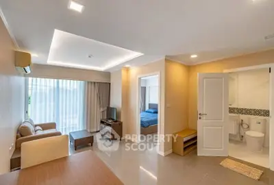 Modern apartment interior with open living room and bedroom view