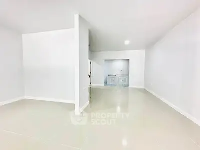 Spacious open-plan living area with sleek tile flooring and modern design
