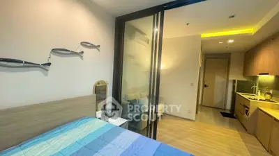 Modern studio apartment with cozy bedroom and compact kitchen