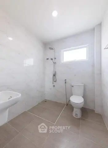 Spacious modern bathroom with sleek fixtures and elegant tile design.
