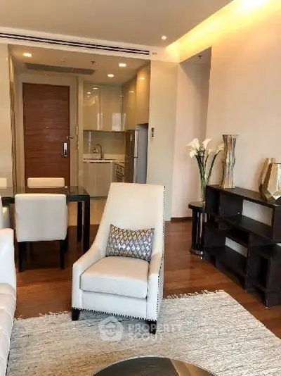 Elegant living room with modern furniture and open kitchen layout in a stylish apartment.