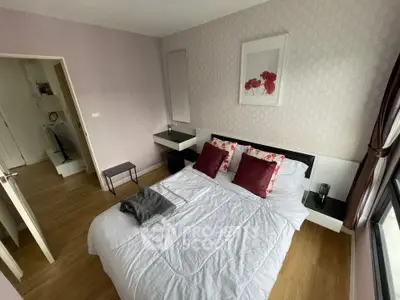 Cozy bedroom with modern decor and large window offering natural light